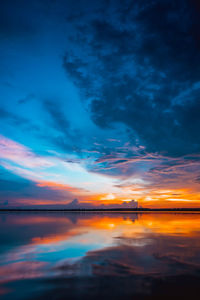 Scenic view of dramatic sky over sea during sunset