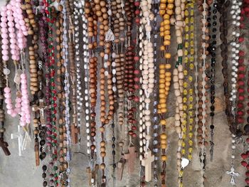 Full frame shot of multi colored rosaries for sale in market