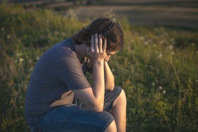 Young woman sitting on field