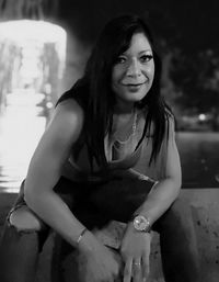 Portrait of smiling young woman sitting outdoors