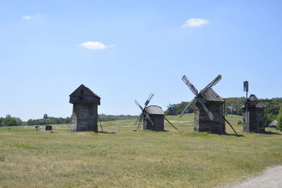 Traditional windmill on field against sky