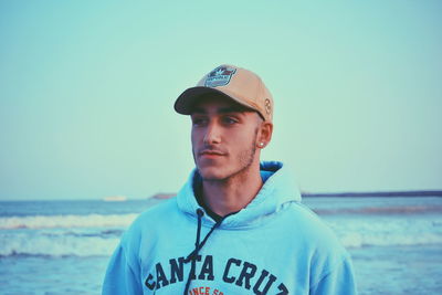 Portrait of young man against sea