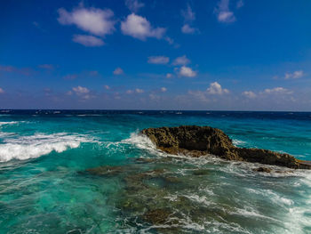 Scenic view of sea against blue sky