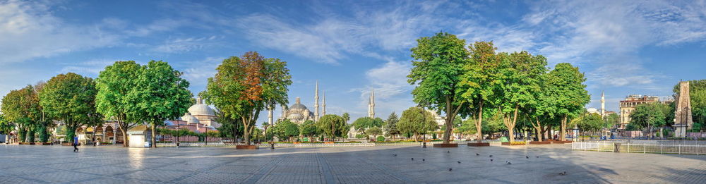 Panoramic view of trees and street against sky