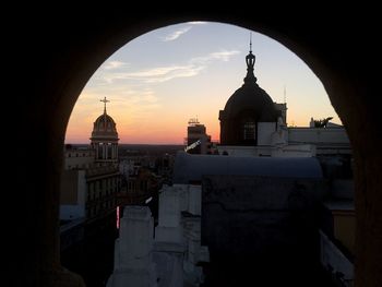 Silhouette cathedral against sky during sunset