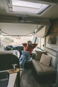 Rear view of woman sitting in car