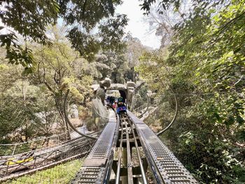 Rear view of man walking on footbridge