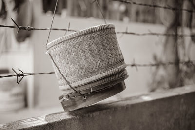 Close-up of rope hanging on metal fence