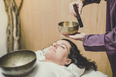 Midsection of woman holding hand bell