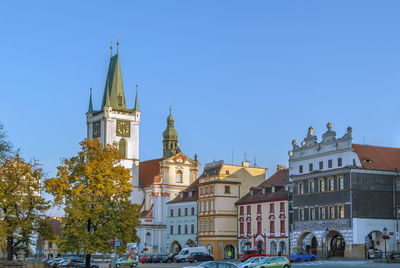 View of buildings in city against clear blue sky