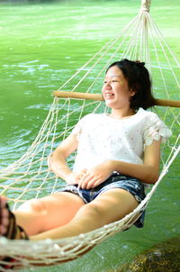 Smiling young woman sitting in boat