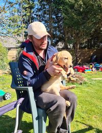 Man with dog sitting in park