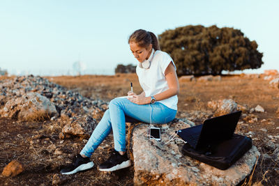 Full length of senior woman using mobile phone