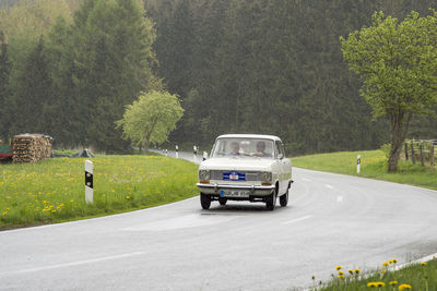 Car on road against rural landscape