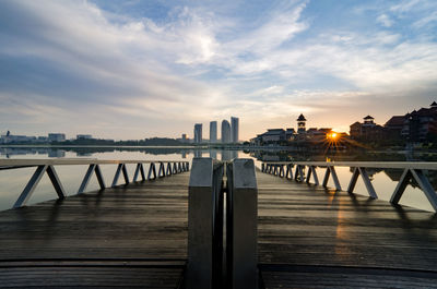 View of jetty in city against sky