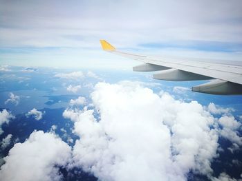 Cropped image of airplane flying over mountain