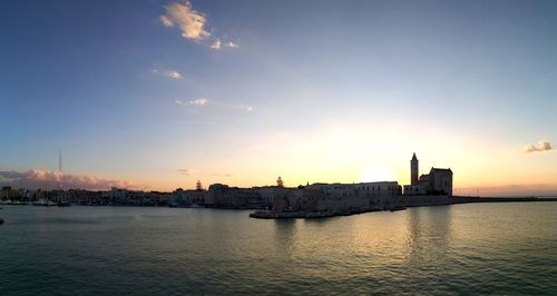 Buildings in city at sunset