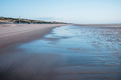 Scenic view of beach against clear sky