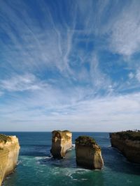 Rocks in sea against sky