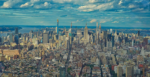 Aerial view of modern buildings in city against sky