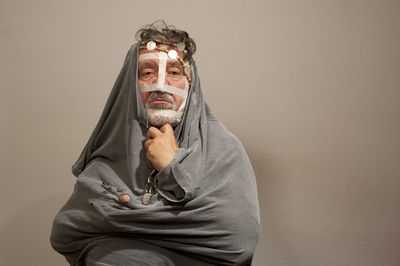 Portrait of man wearing mask against white background