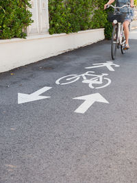 Low section of person riding bicycle on road