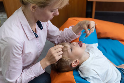 Midsection of doctor examining patient in hospital