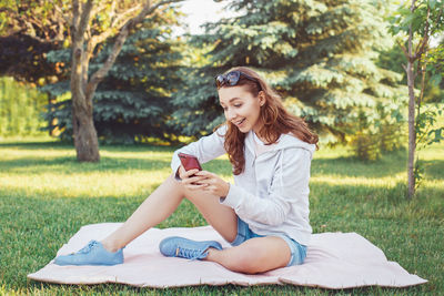 Young woman sitting on grass