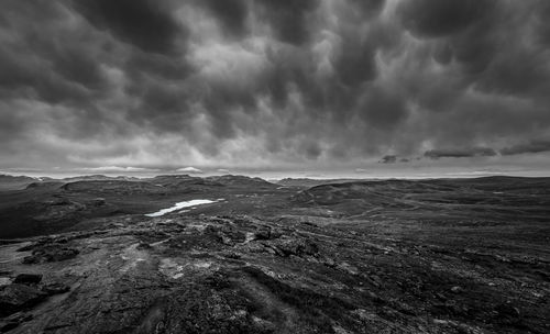 Scenic view of storm clouds over landscape