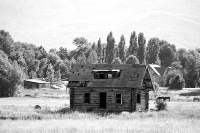 Abandoned barn on field against sky