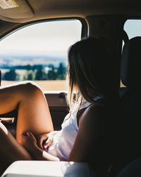 Rear view of woman sitting in bus