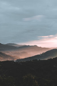 Scenic view of silhouette mountains against sky during sunset