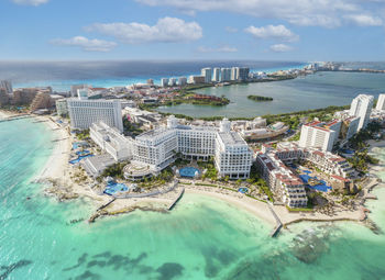 High angle view of townscape by sea against sky