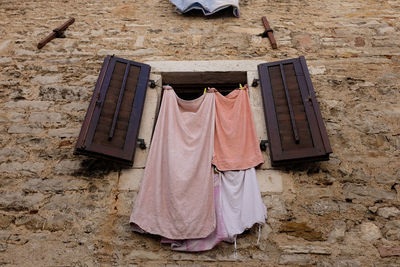 Drying laundry out of a window on clothes line