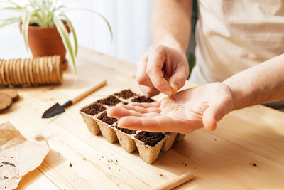 Midsection of woman preparing food on table