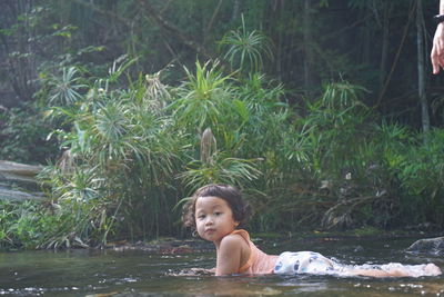 Portrait of young woman in water