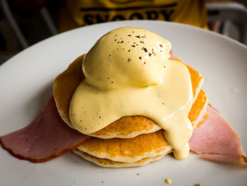 Close-up of eggs benedict on garnished on pancakes in plate