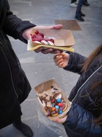 Midsection of man holding food