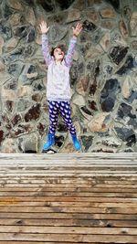 Portrait of a girl sitting on boardwalk