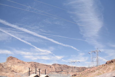 Low angle view of vapor trail in desert against sky