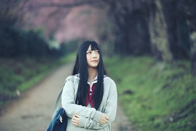 Portrait of young woman standing outdoors