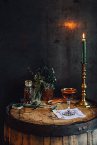 Still life with manhattan cocktail on bourbon whiskey barrel with candlestick