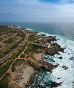 Aerial view of sea and landscape against sky