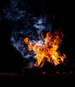 Bonfire on log at night