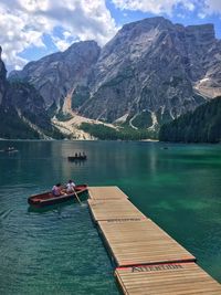 Scenic view of lake by mountains against sky