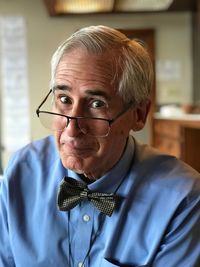 Portrait of senior man wearing eyeglasses while sitting at home