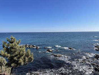 Scenic view of sea against clear blue sky