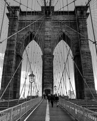 People walking on bridge in city