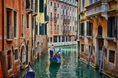 View of boats in canal along buildings