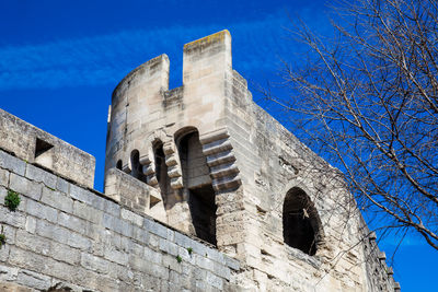 Low angle view of old building against blue sky